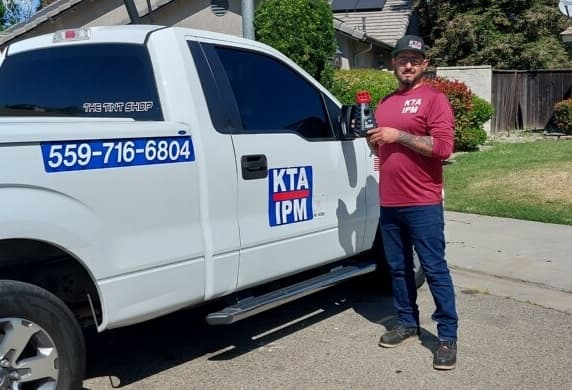 Ruben Gutierrez, veteran owner-operator of KTA IPM, standing by his branded KTA IPM service truck in Madera, CA.