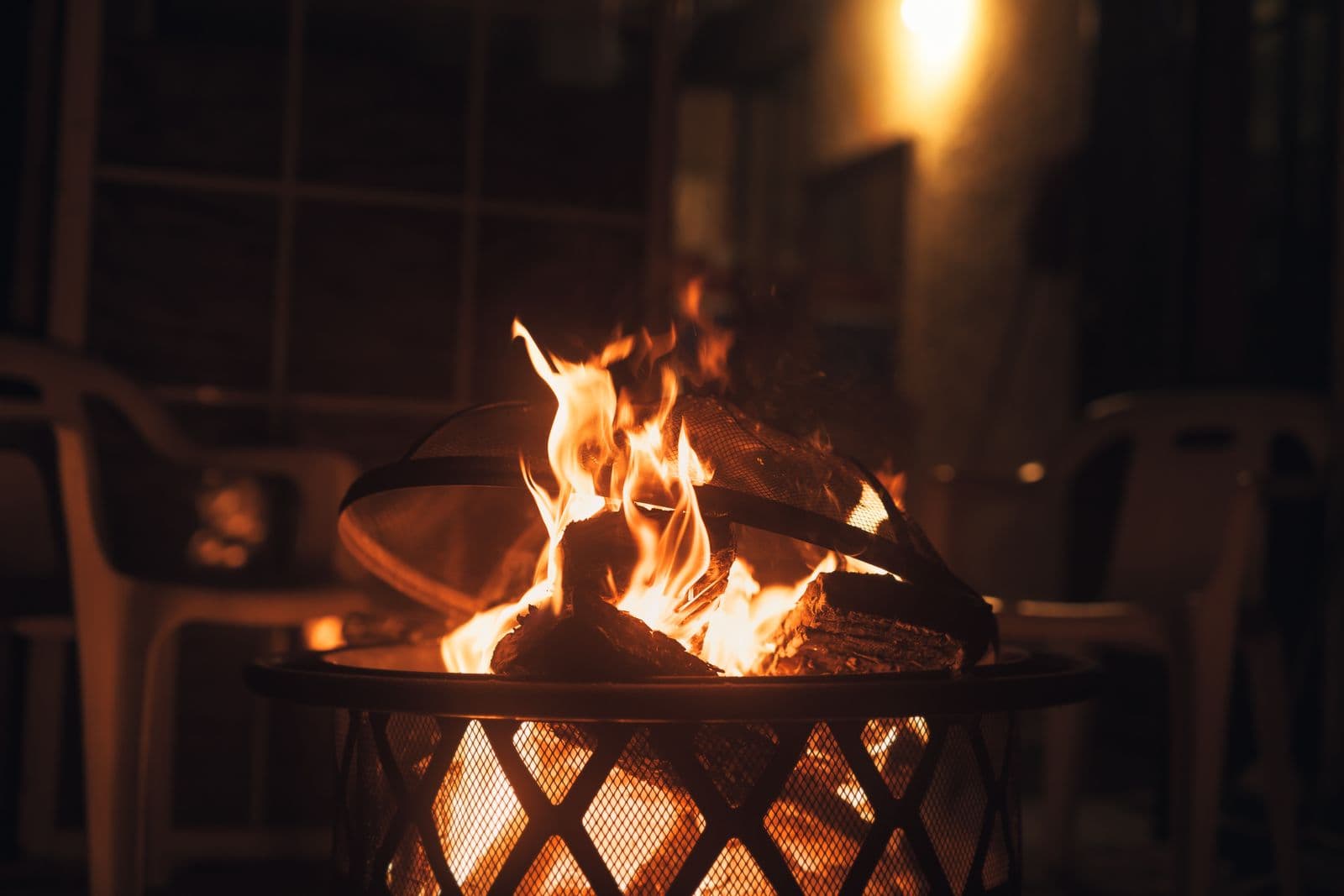 A backyard fire pit at sunset, comfortable and mosquito-free after KTA IPM treatment.