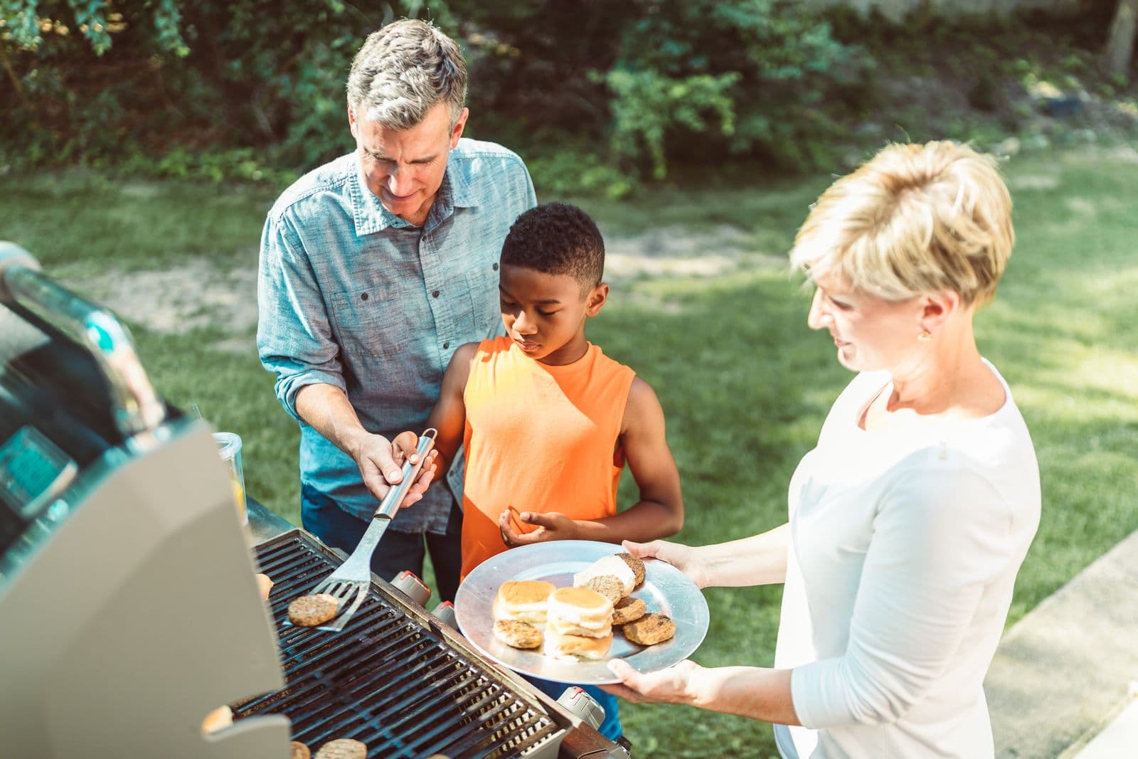 Family enjoying a backyard barbecue without mosquitoes in Madera, CA.