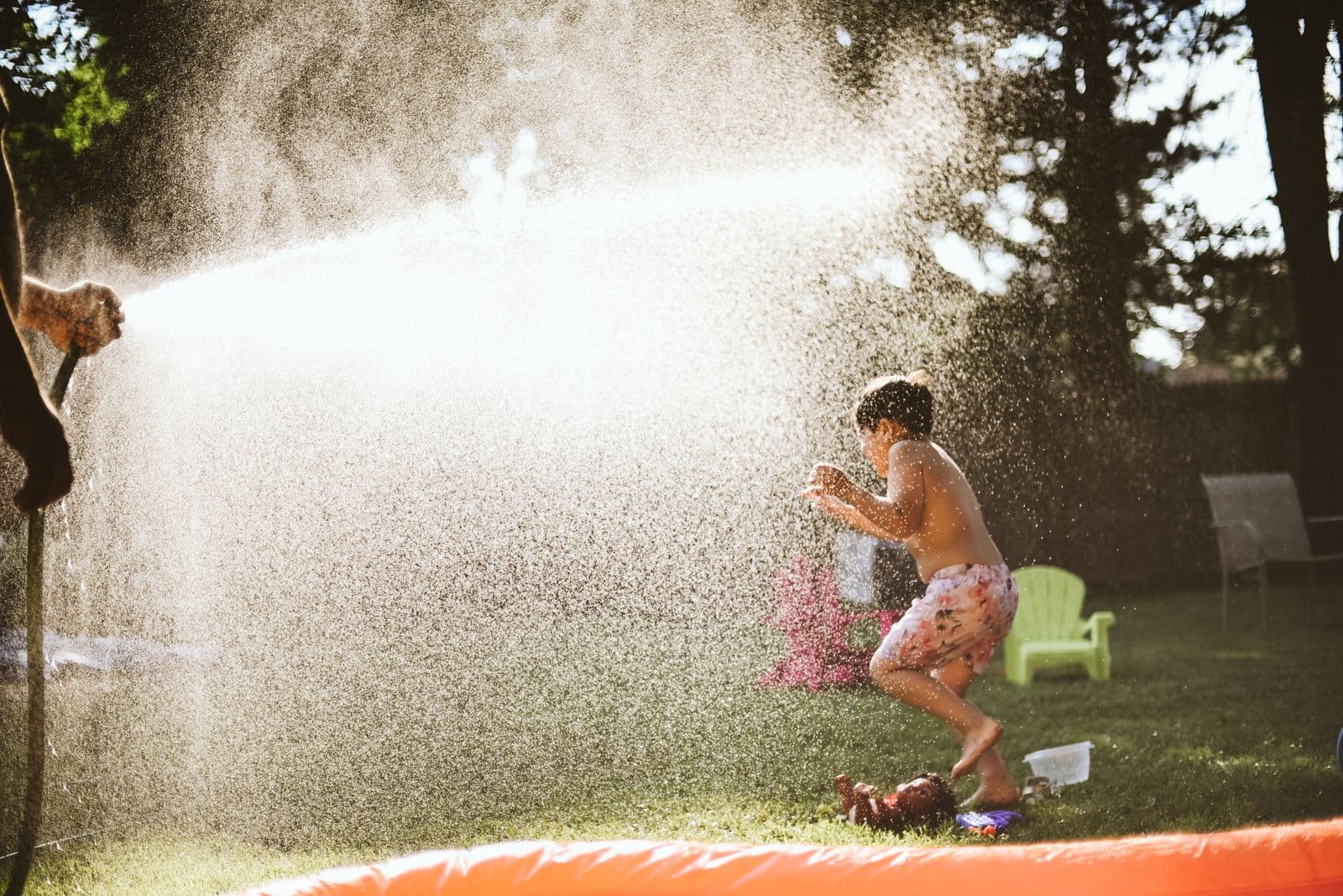 Kids playing outside in a mosquito-protected backyard in the Central Valley.